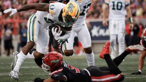 Edmonton Elks' Javon Leake escapes a tackle from Calgary Stampeders' Branden Dozier during second half CFL football action in Calgary, Monday, Sept. 2, 2024. (Jeff McIntosh/CP Photo)