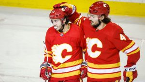 Calgary Flames' Rasmus Andersson, right, congratulates Johnny Gaudreau on his goal during a game against the San Jose Sharks in Calgary on March 22, 2022. (Jeff McIntosh/CP)