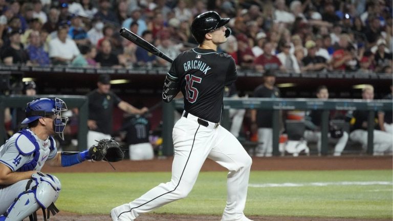 Arizona Diamondbacks' Randal Grichuk, right, watches the flight of his three-run home run as Los Angeles Dodgers catcher Austin Barnes, left, looks on during the second inning of a baseball game Sunday, Sept. 1, 2024, in Phoenix. (Ross D. Franklin/AP Photo)
