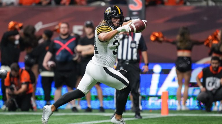 Hamilton Tiger-Cats' Ante Litre scores the winning touchdown against the B.C. Lions in overtime during a CFL football game, in Vancouver, on Friday, September 27, 2024. (Darryl Dyck/CP)