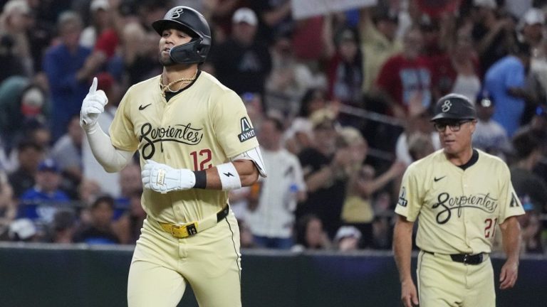 Arizona Diamondbacks' Lourdes Gurriel Jr. rounds the bases after hitting a home run against the Los Angeles Dodgers as Diamondbacks third base coach Tony Perezchica, right, looks on during the third inning of a baseball game Saturday, Aug. 31, 2024, in Phoenix. (Ross D. Franklin/AP Photo)
