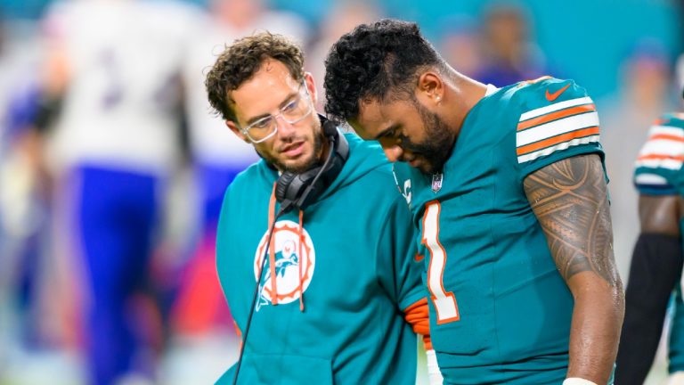 Miami Dolphins quarterback Tua Tagovailoa (1) walks off of the field with head coach Mike McDaniel after suffering an injury during an NFL football game against the Buffalo Bills, Thursday, Sept. 12, 2024, in Miami Gardens, Fla. (Doug Murray/AP)