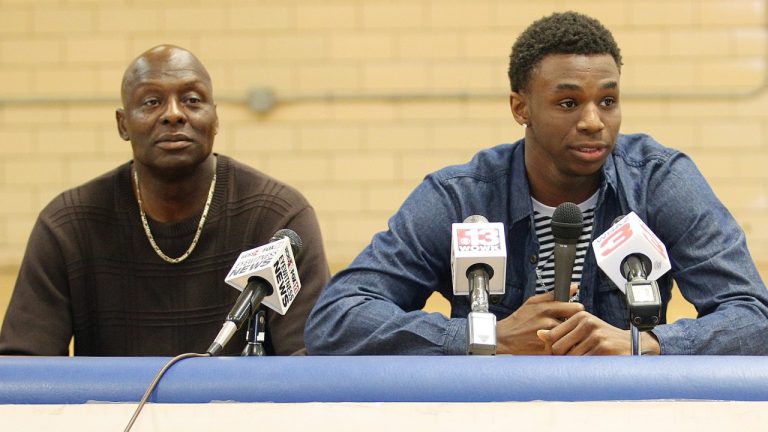 Andrew Wiggins, centre, flanked by his dad Mitchell Wiggins, as he announces his commitment to the University of Kansas during a ceremony, Tuesday, May 14, 2013. (AP Photo/The Herald-Dispatch, Sholten Singer)