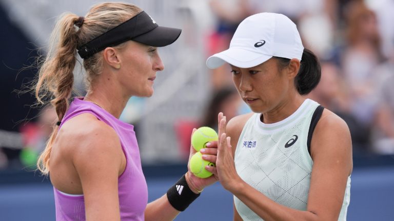 Kristina Mladenovic (left) and Shuai Zhang during confer their doubles tennis match against Bianca Fernandez and Leylah Fernandez at the National Bank Open in Toronto on Saturday August 10, 2024. (Chris Young/CP)