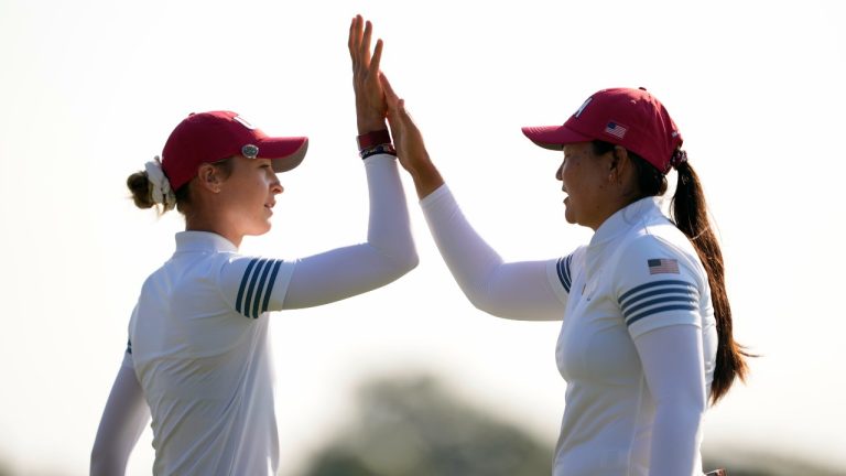 United States' Nelly Korda, left, is celebrates with teammate Allisen Corpuz after sinking a putt on the 10th hole during a Solheim Cup golf tournament foursome match at Robert Trent Jones Golf Club, Saturday, Sept. 14, 2024, in Gainesville, Va. (AP/Matt York)