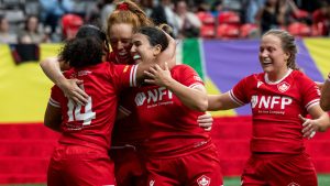 Canada's Fancy Bermudez, left, celebrates with teammates after scoring a try during WXV 1 women's rugby union action against France in Vancouver, Sunday, Sept. 29, 2024. (Ethan Cairns/CP)