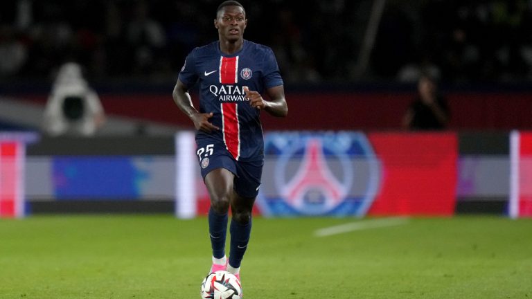 PSG's Nuno Mendes runs with the ball during the French League 1 soccer match between Paris Saint-Germain and Montpellier at the Parc des Princes in Paris, Friday, Aug. 23, 2024. (Thibault Camus/AP)