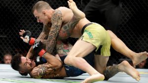 Renato Moicano, top, hits Cub Swanson during their featherweight mixed martial arts bout at UFC 227 in Los Angeles in 2018. (Chris Carlson/AP)