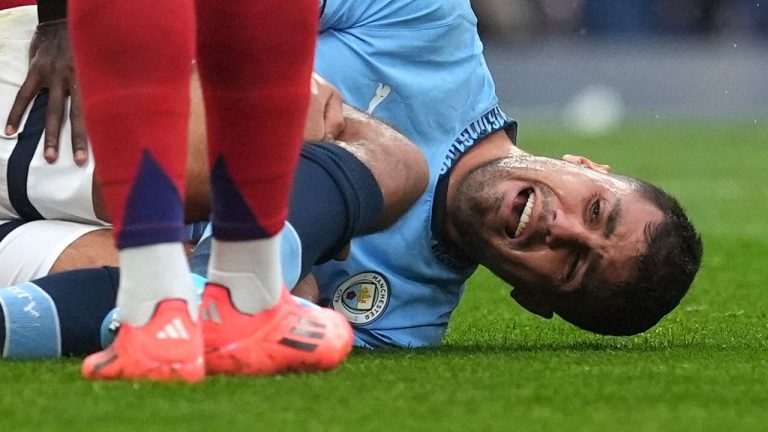 Manchester City's Rodri reacts to an injury, during the English Premier League soccer match between Manchester City and Arsenal at the Etihad stadium in Manchester, England, Sunday, Sept. 22, 2024. (Martin Rickett/PA via AP)