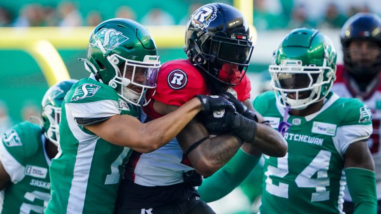 Ottawa Redblacks receiver Justin Hardy (centre) is tackled by Saskatchewan Roughriders defensive back Amari Henderson (16) during the second half of CFL football action in Regina, on Saturday, September 28, 2024. (Heywood Yu/CP)