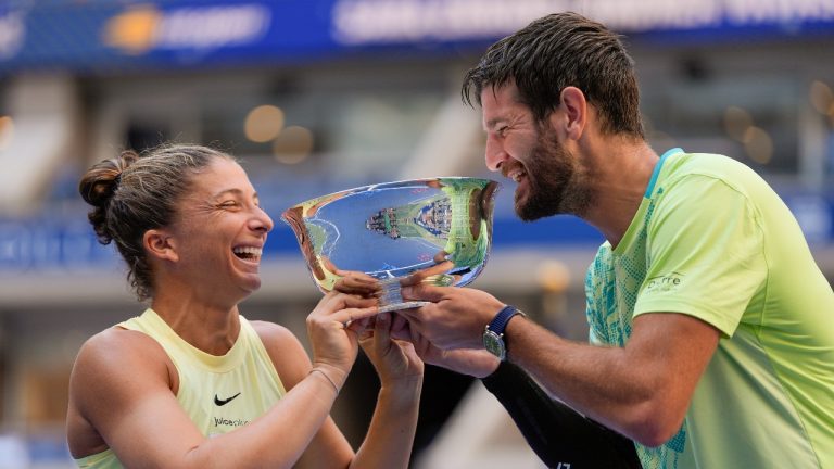 Sara Errani, of Italy, and Andrea Vavassori, of Italy, hold up the championship trophy after defeating Taylor Townsend, of the United States, and Donald Young, of the United States, in the mixed doubles final of the U.S. Open tennis championships, Thursday, Sept. 5, 2024, in New York. (AP/Julia Nikhinson)