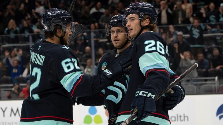 From left to right, Seattle Kraken defenseman Brandon Montour, forward Mitchell Stephens and forward Ryan Winterton celebrate after a goal during the second period of an NHL preseason hockey game against the Vancouver Canucks, Friday, Sept. 27, 2024, in Seattle. (AP Photo/Stephen Brashear)