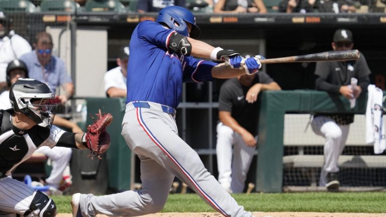 Texas Rangers' Corey Seager hits a solo home run during the fourth inning of a baseball game against the Chicago White Sox in Chicago, Thursday, Aug. 29, 2024. (Nam Y. Huh/AP Photo)
