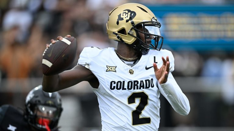 Colorado quarterback Shedeur Sanders (2) throws a pass as Central Florida defensive back Braeden Marshall (4) defends during the first half of an NCAA college football game, Saturday, Sept. 28, 2024, in Orlando, Fla. (AP Photo/Phelan M. Ebenhack)