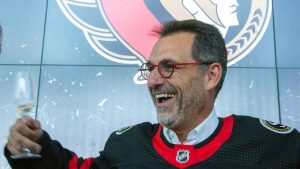 Ottawa Senators NHL hockey team owner Michael Andlauer (centre) smiles during a press conference in Ottawa. (Fred Chartrand/THE CANADIAN PRESS)