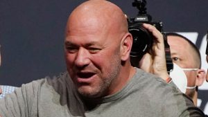 Dana White stands between fighters during a ceremonial UFC weigh-in. (John Locher/AP)