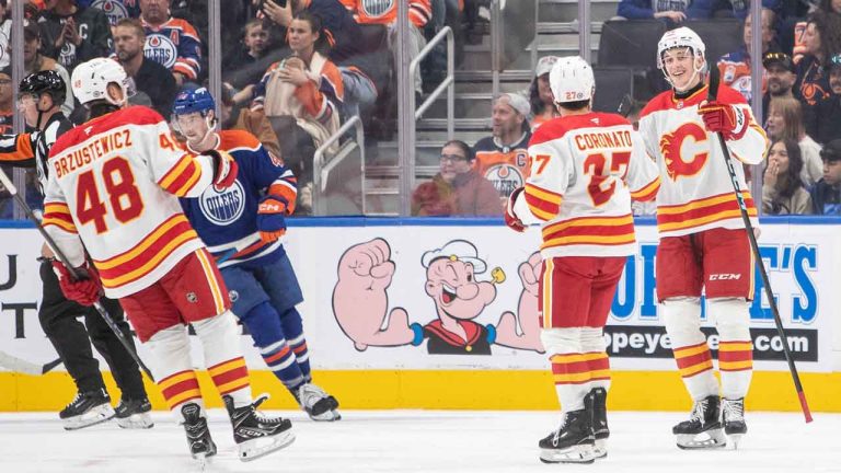 Calgary Flames Hunter Brzustewicz (48), Matt Coronato (27), and Sam Honzek (42) celebrate as Edmonton Oilers Noah Philp (48) skates off during second period NHL pre-season action. (Amber Bracken/THE CANADIAN PRESS)