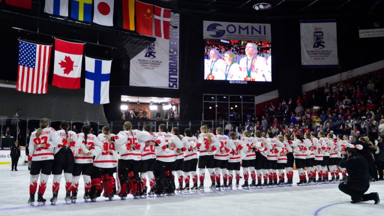 Canada's women's national team stands for their national anthem as flags are raised after their win against the United States in the final at the IIHF Women's World Hockey Championships in Utica, N.Y., Sunday, April 14, 2024. (Adrian Kraus/AP)