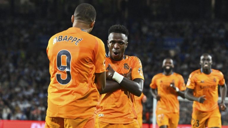 Real Madrid's Kylian Mbappe celebrates with Vinicius Junior, 2nd left, after scoring his side's second goal from a penalty kick during a Spanish La Liga soccer match between Real Sociedad and Real Madrid at the Reale Arena in San Sebastian, Spain, Saturday, Sept. 14, 2024. (Miguel Oses/AP Photo)
