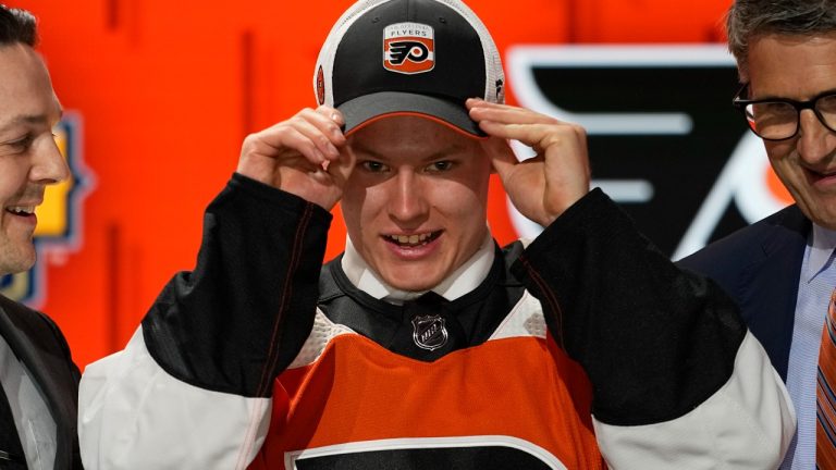 Matvei Michkov adjust his Philadelphia Flyers hat after being picked by the team during the first round of the NHL hockey draft Wednesday, June 28, 2023, in Nashville, Tenn. (George Walker IV/AP)