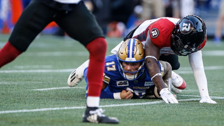 Winnipeg Blue Bombers quarterback Chris Streveler (17) gets tackled by Ottawa Redblacks' Adarius Pickett (6) during first half CFL action in Winnipeg Friday, July 5, 2024. (John Woods/THE CANADIAN PRESS)