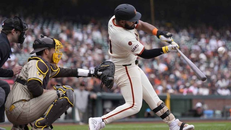 San Francisco Giants' Heliot Ramos, right, hits a home run in front of San Diego Padres catcher Kyle Higashioka during the ninth inning of a baseball game. (Jeff Chiu/AP)
