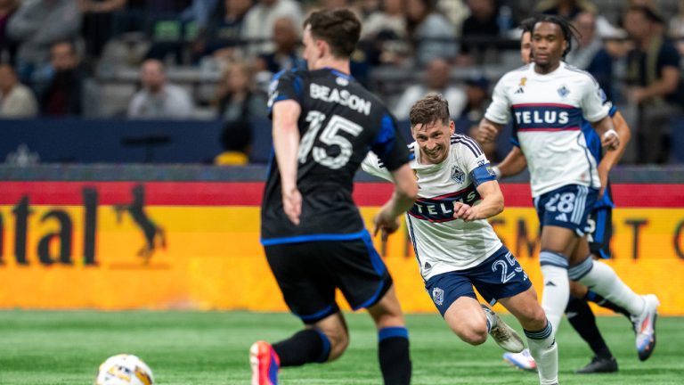 Vancouver Whitecaps' Ryan Gauld (25) and San Jose Earthquakes' Tanner Beason (15) vie for the the ball during the second half of an MLS soccer match in Vancouver, on Saturday, September 14, 2024. (Ethan Cairns/CP)