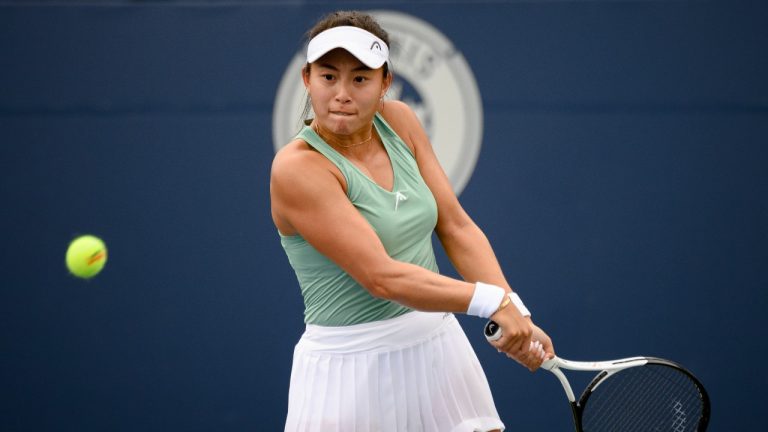 Carol Zhao, of Canada, returns the ball during a match against Amanda Anisimova, of the USA, at the National Bank Open tennis tournament in Toronto, on Tuesday, Aug. 9, 2022. (Christopher Katsarov/THE CANADIAN PRESS)