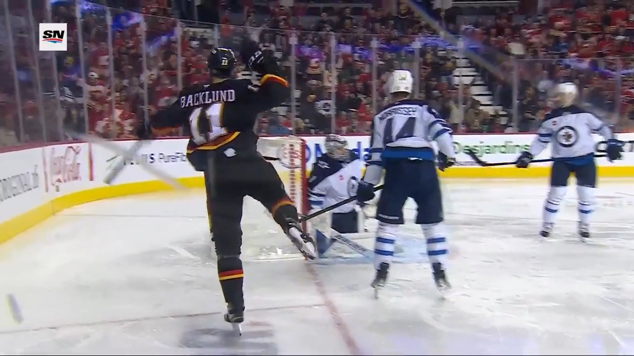 Flames keep puck alive before Backlund sneaks one past Comrie