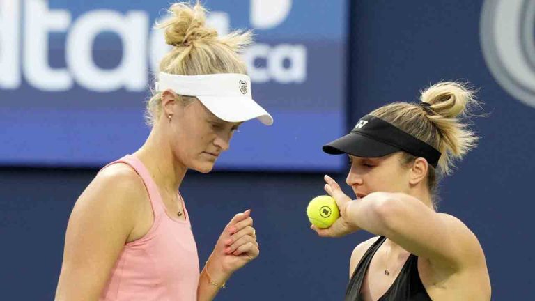 Gabriela Dabrowski, right, of Ottawa, and teammate Erin Routliffe, of New Zealand, strategize during women's doubles semifinal action at the National Bank Open, in Toronto, Sunday, Aug. 11, 2024. (Frank Gunn/CP)