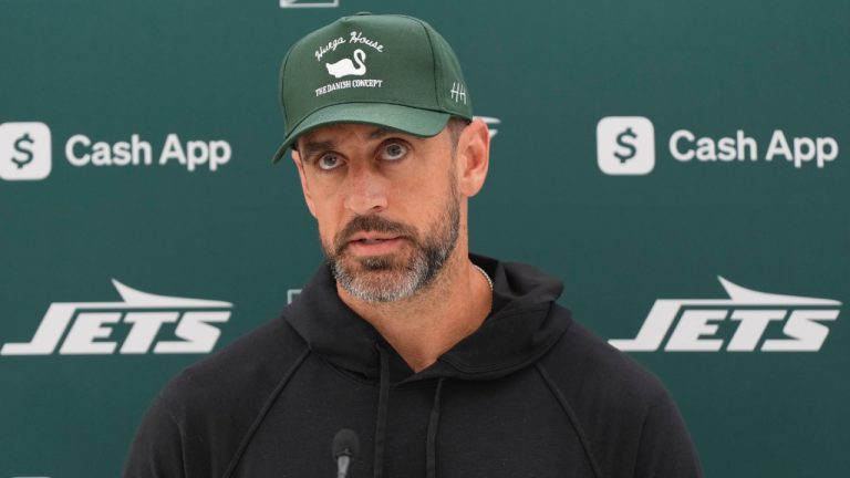 New York Jets quarterback Aaron Rodgers (8) speaks during a press conference in Ware, England, Friday, Oct. 4, 2024, ahead of the game between New York Jets and Minnesota Vikings at the Tottenham Hotspur stadium on Sunday. (Alastair Grant/AP)