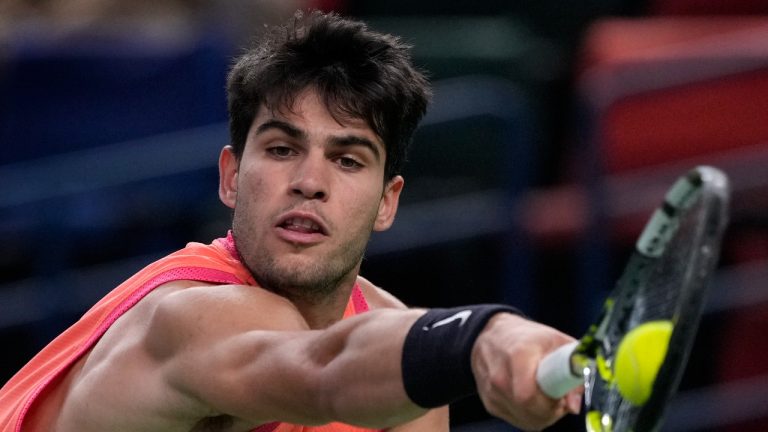 Carlos Alcaraz of Spain plays a backhand return against Tomas Machac of the Czech Republic during the men's singles quarterfinals match in the Shanghai Masters tennis tournament at Qizhong Forest Sports City Tennis Center in Shanghai, China, Thursday, Oct. 10, 2024. (AP/Andy Wong)