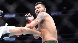 Anthony Hernandez taking a kick to the body during a UFC middleweight bout. (Mark J. Terrill/AP)