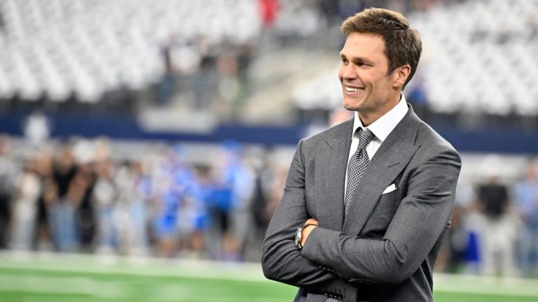 Analyst Tom Brady stands on the field during warmups before first an NFL football game between the Detroit Lions and Dallas Cowboys in Arlington, Texas, Sunday, Oct. 13, 2024. (Jerome Miron/AP Photo)