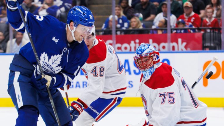 Toronto Maple Leafs' Steven Lorentz (18) watches as a puck goes wide of Montreal Canadiens goaltender Jakub Dobes (75) during second period pre-season NHL hockey action in Toronto on Thursday, September 26, 2024. (Cole Burston/CP)