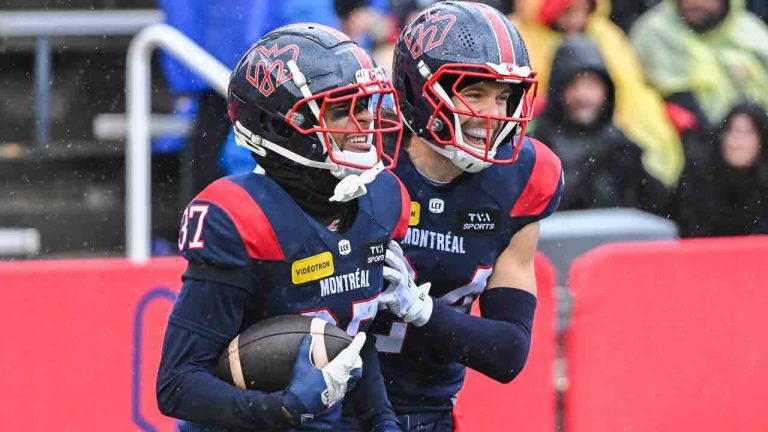 Montreal Alouettes' Wesley Sutton (37) reacts with teammate Marc-Antoine Dequoy (24) after catching an interception during second half CFL football action against the Ottawa Redblacks in Montreal, Monday, Oct. 14, 2024. (Graham Hughes/CP)