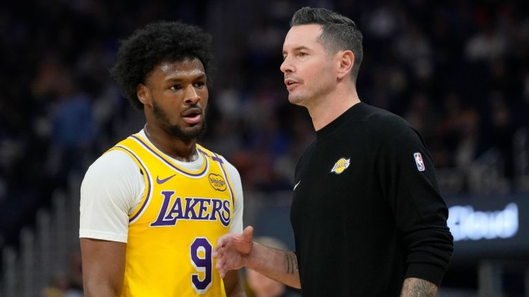 Los Angeles Lakers head coach JJ Redick, right, talks with Los Angeles Lakers guard Bronny James (9) during the first half of an NBA preseason basketball game. (Jeff Chiu/AP)