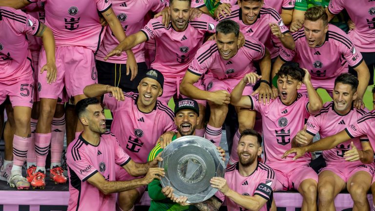 Inter Miami forward Lionel Messi, front, centre right, celebrates with his teammates Sergio Busquets, front, centre left, Luis Suárez, second row, left, and Drake Callender, centre in green, after winning the Supporters' Shield, defeating the New England Revolution at Chase Stadium in Fort Lauderdale, Fla., Saturday, Oct. 19, 2024. (David Santiago/Miami Herald via AP) 