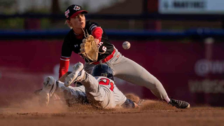 Ashton Lansdell #21 of Team USA slides into second as Mia Valcke #6 of Team Canada takes a late throw during a WBSC Women's Baseball World Cup game at Port Arthur Stadium on Tuesday, July 30, 2024 in Thunder Bay, Ont. (Jean Fruth via AP)