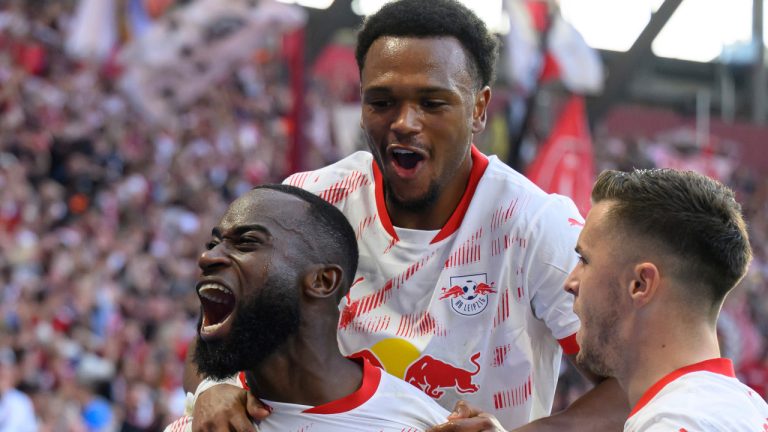 From left, Leipzig's Lutsharel Geertruida celebrates with Lois Openda and Christoph Baumgartner after scoring during the German Bundesliga soccer match between RB Leipzig and SC Freiburg at the Red Bull Arena in Leipzig, Germany, Saturday, Oct. 26, 2024. (Hendrik Schmidt/dpa via AP) 