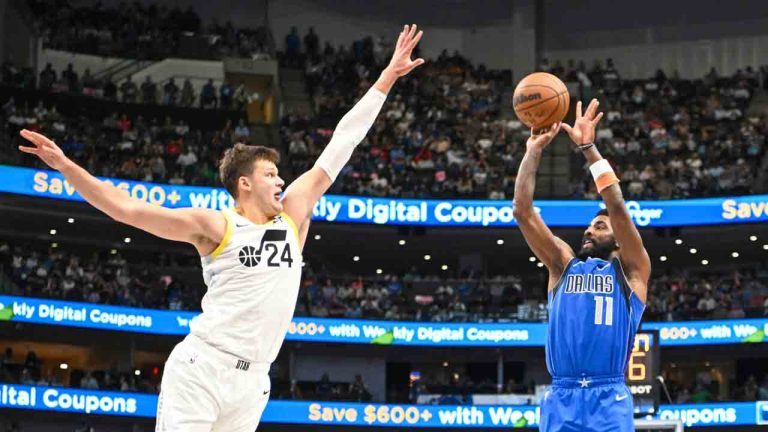 Dallas Mavericks guard Kyrie Irving (11) takes a jump shot over Utah Jazz centre Walker Kessler (24) in the second half of an NBA basketball game, Monday, Oct. 28, 2024, in Dallas. (Albert Pena/AP)