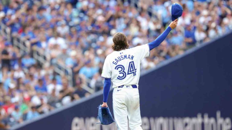 Toronto Blue Jays pitcher Kevin Gausman acknowledges the crowd after Texas Rangers Adolis García lines out to Jays outfielder George Springer at right field during ninth inning American League MLB baseball action in Toronto on Saturday, July 27, 2024. (Chris Young/CP)