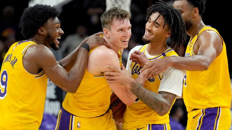 Los Angeles Lakers guard Dalton Knecht, second from left, celebrates with Lakers guard Bronny James (9), guard Jalen Hood-Schifino, second from right, and forward Armel Traore as time expires in overtime of an NBA preseason basketball game against the Phoenix Suns Thursday, Oct. 17, 2024, in Phoenix. The Lakers' Knecht had 35 points and the Lakers won 128-122. (Ross D. Franklin/AP)