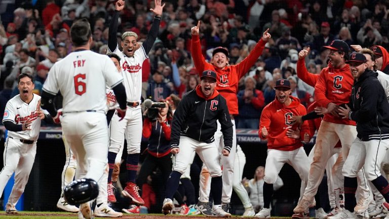 Cleveland Guardians players wait for David Fry (6) to cross home plate after hitting a game-winning two-run home run against the New York Yankees during the 10th inning in Game 3 of the baseball AL Championship Series Thursday, Oct. 17, 2024, in Cleveland. The Guardians won 7-5. (Jeff Roberson/AP)