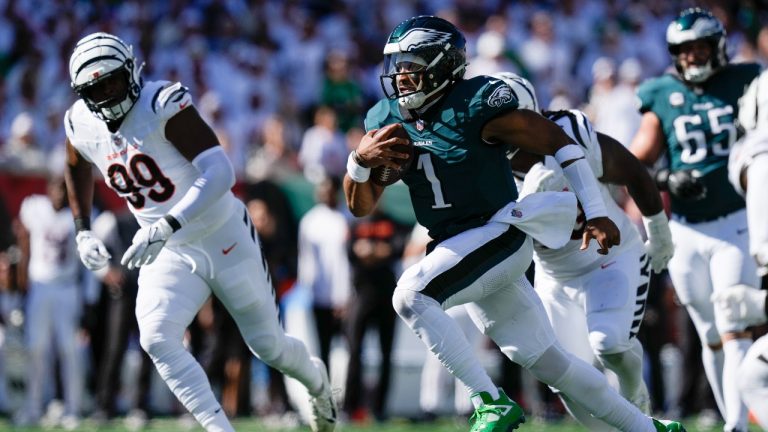 Philadelphia Eagles quarterback Jalen Hurts (1) runs for yardage as Cincinnati Bengals defensive end Myles Murphy (99) tries to stop him during the first half of an NFL football game, Sunday, Oct. 27, 2024 in Cincinnati. (AP/Carolyn Kaster)