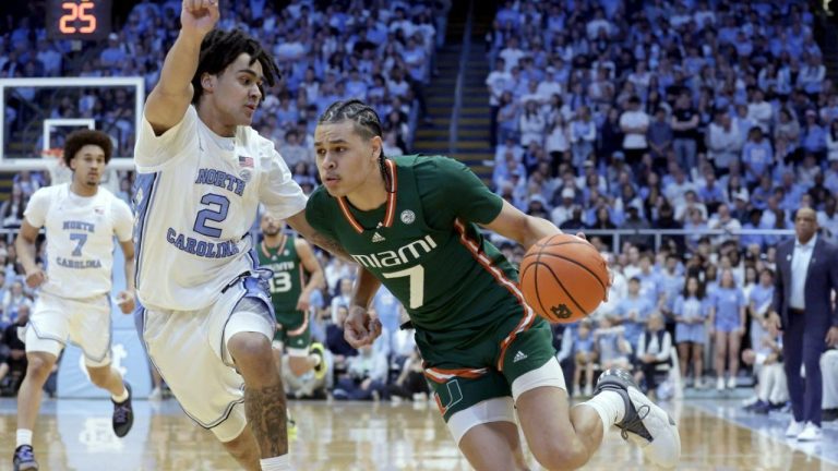 Miami guard Kyshawn George (7) drives against North Carolina guard Elliot Cadeau (2) during an NCAA college basketball game Monday, Feb. 26, 2024, in Chapel Hill, N.C. (Chris Seward/AP Photo)
