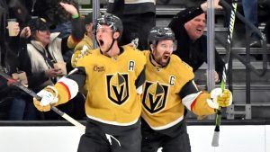 Vegas Golden Knights center Jack Eichel, left, and right wing Mark Stone, right, celebrate after Eichel's goal against the St. Louis Blues during the first period of an NHL hockey game Friday, Oct. 11, 2024, in Las Vegas. (AP Photo/David Becker)