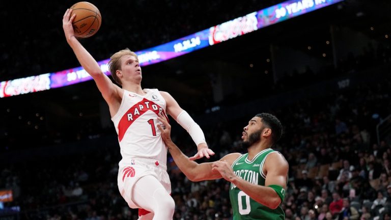 Toronto Raptors guard Gradey Dick (1) drives past Boston Celtics forward Jayson Tatum (0) during first half NBA pre-season basketball action in Toronto on Tuesday, October 15, 2024. (Nathan Denette/CP)