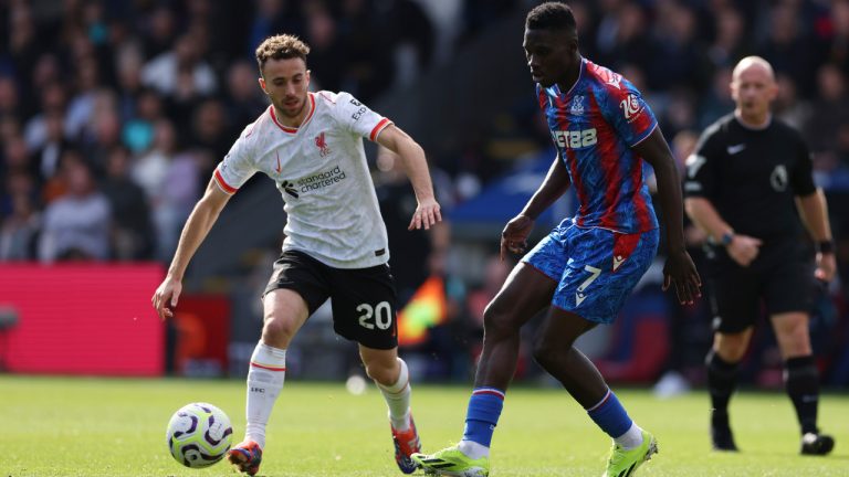 Liverpool's Diogo Jota, left, and Crystal Palace's Ismaila Sarr challenge for the ball the English Premier League soccer match between Crystal Palace and Liverpool at Selhurst Park in London, Saturday, Oct. 5, 2024.(Ian Walton/AP)