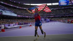 Hunter Woodhall from the U.S. celebrates after winning the men's 400 m. T62 final at the 2024 Paralympics, Friday, Sept. 6, 2024, in Paris, France. (AP Photo/Thibault Camus)